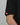 Sleeve detail of the Black Red Shield Elite Mens Tee, highlighting the red Legacy G sleeve tag against a light gray background.