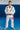 Adult athlete wearing the white GB1 Kimono standing on a blue mat, featuring the Red Shield patch on the chest, Gracie Barra lapel patch, and reinforced jacket and pant design