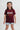 Young girl wearing maroon t-shirt with puff print "Gracie Barra Brazilian Jiu-Jitsu" logo, smiling against a white background.