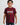 Young boy wearing maroon t-shirt with puff print "Gracie Barra Brazilian Jiu-Jitsu" logo and jeans, standing against a white background.