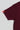 Close-up of maroon youth t-shirt sleeve with red Gracie Barra Legacy G tag.